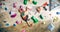 Strong Experienced Rock Climber Practicing Solo Climbing on Bouldering Wall in a Gym. Man Exercising