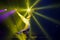 Strong female aerial acrobat make performance upside down on aerial hoop backlit yellow lights.