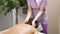 Strong female hands giving doing back, shoulder and neck massage to young brunette woman at the medical center