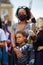 A strong female leader wears a Black Lives Matter PPE face mask and hugs her Superhero son at a BLM protest in Richmond, North