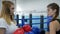Strong female rivals in gloves meet for boxing match on ring in club