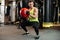 Strong fit sportsman doing squats with weight ball