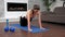 Strong fit woman in sportswear doing push-up exercise on fitness yoga blue mat