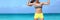 Strong fitness woman banner crop with copyspace on sky. Body crop of athlete showing off slim body on beach. Weight loss