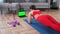 Strong fitness woman doing plank on yoga mat looking green screen laptop display