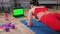 Strong fitness woman doing plank on yoga mat looking green screen laptop display