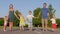 A strong friendly family holding hands is standing on the road.