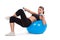 Strong girl lifting dumbbells on fitball
