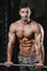 Strong and handsome athletic young man muscles abs and biceps