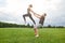 Strong and healthy. Young and beautiful couple practicing acro yoga on a grass in open field. Yoga in pair.