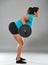 Strong hispanic woman doing barbell rows