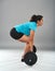 Strong hispanic woman doing deadlift