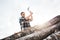 Strong lumberjack holds ax with both hands and cuts large tree