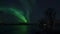 Strong majestic aurora borealis, northern light over bridge and Tromso city
