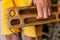 strong male hand of a rock climber holds a board for training finger strength.