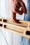 strong male hand of a rock climber holds a board for training finger strength.