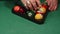 Strong male hands collect billiard balls in a triangle, close-up. Billiard player's hands put balls in the center