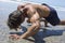 Strong man doing intense bear crawl beach workout