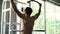 Strong man doing pull ups exercise on horizontal bar at the gym