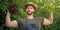 strong man greengrocer in straw hat with lettuce leaves