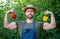 strong man greengrocer in straw hat with sweet pepper