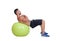 Strong man practicing abdominal on a big ball