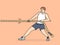 Strong man pulls rope while participating in sports competitions or training in fitness club