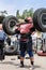 Strong man raises a heavy barbell. Weightlifting