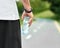 Strong man`s hand keeping water bottle standing on racetrack.