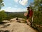 Strong man tourist with a backpack, walks in the mountains