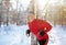 Strong mature man doing fitness workout at snowy winter park. Outdoor endurance exercises