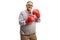 Strong mature man wearing red boxing gloves and smiling