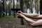 Strong Men`s hands hold a gun against  forest background. Danger situation in the forest