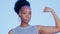 Strong, muscle and face of a black woman with biceps isolated on a blue background in a studio. Serious, confident and