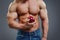 Strong Muscle Man holding a Red Apple