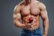 Strong Muscle Man holding a Red Apple