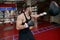 Strong muscular boxer hitting punching speed bag in gym