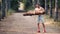 Strong muscular man lifting a log on a forest road