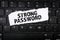 Strong Password. Torn paper on a black computer keyboard