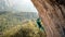 strong and powerful woman rock climber climbs hard tough rock route on overhanging cliff on beautiful natural background