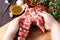 Strong professional man`s hands cutting raw lamb meat, selective focus, close-up