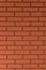 Strong red vertical brick wall background, surface. Red, orange tiles.