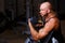 Strong ripped bald man pumping iron. Sports man working out with
