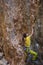 A strong rock climber is training on Turkish rocks, A woman climbs a climbing route