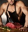 Strong sport man prepare cook beef steak ribs on dark kitchen healthy eating diet concept