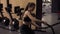 Strong sportive brunette girl in her 20`s performing battle ropes workout at the gym. Slow motion footage.
