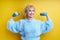 Strong Sportive Senior Woman Lifting Dumbbells Up Isolated On Yellow Background