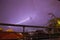 Strong thunder-storm above night mountains and city. Large Bright Lightning Close up. Mediterranian winter night