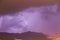 Strong thunder-storm above night mountains and city. Large Bright Lightning Close up. Mediterranian winter night