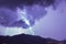 Strong thunder-storm above night mountains and city. Large Bright Lightning Close up. Mediterranian winter night
